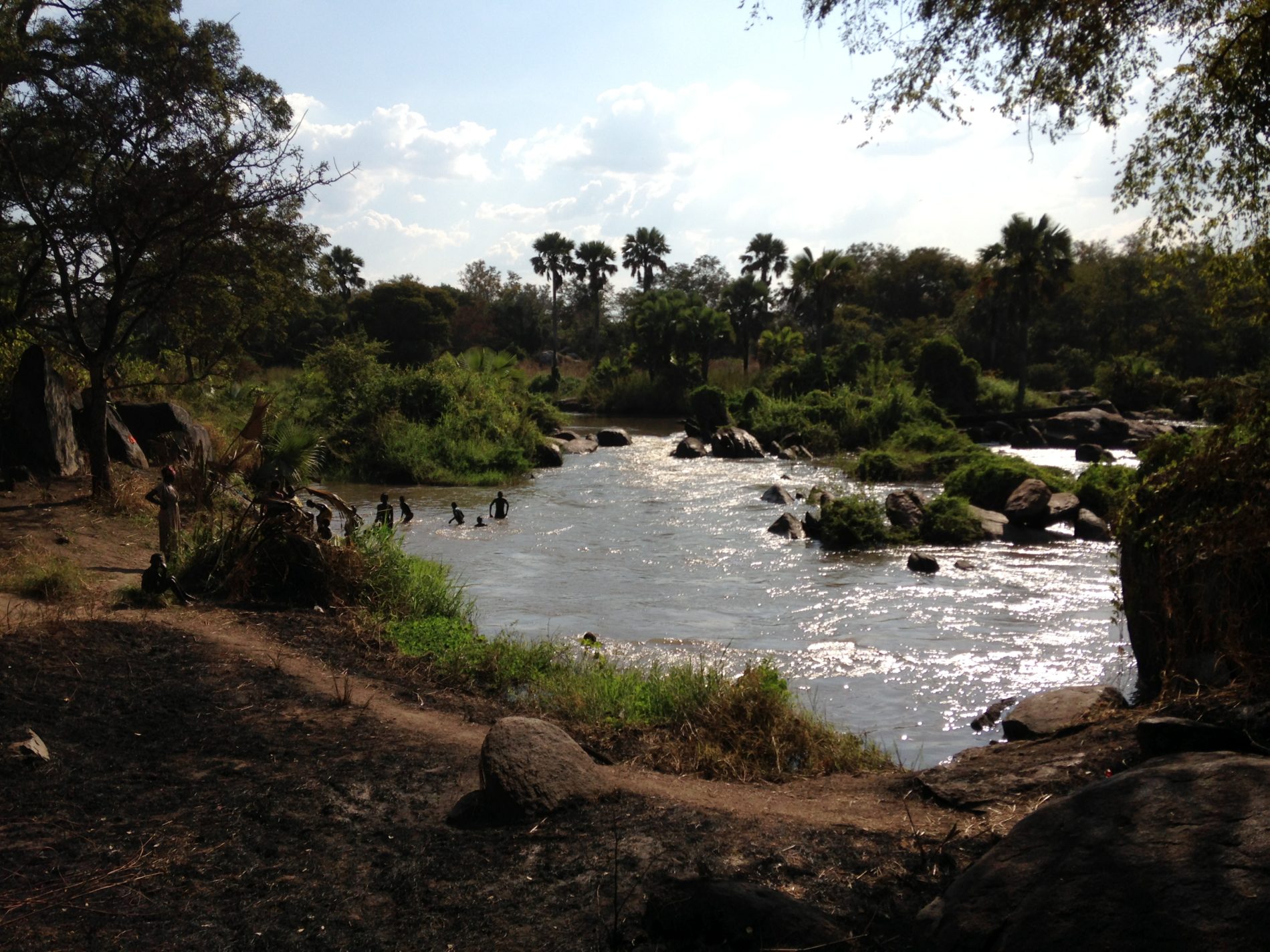 Children in Mvolo playing in the river at a blackfly (the transmitter of onchocerciasis) breeding site