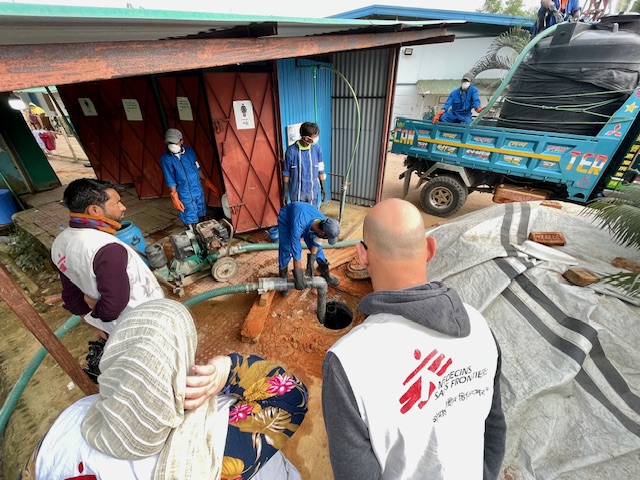 MSF pit emptying team ensuring safe disposal of clinical waste at a healthcare facility 